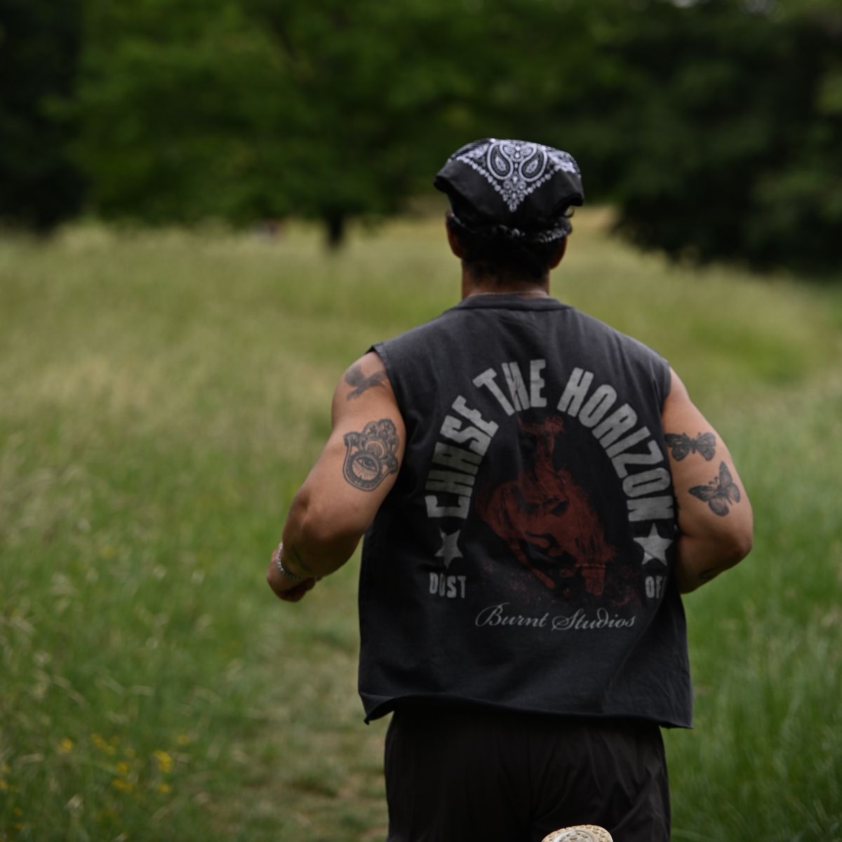 Runner in a Chase the Horizon vest crossing a meadow