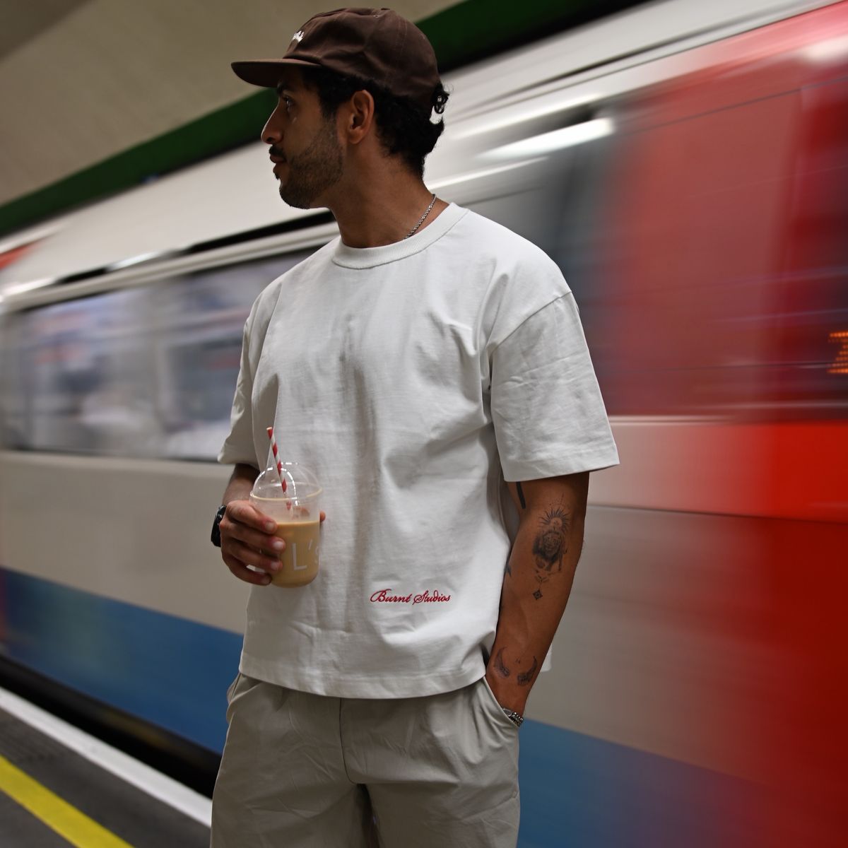 Model in a white Burnt Studios tee on a Tube platform