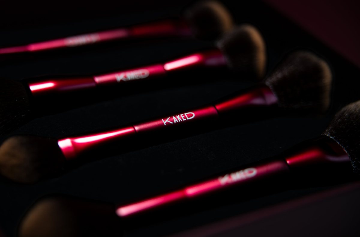A row of red Kaked brushes in low light