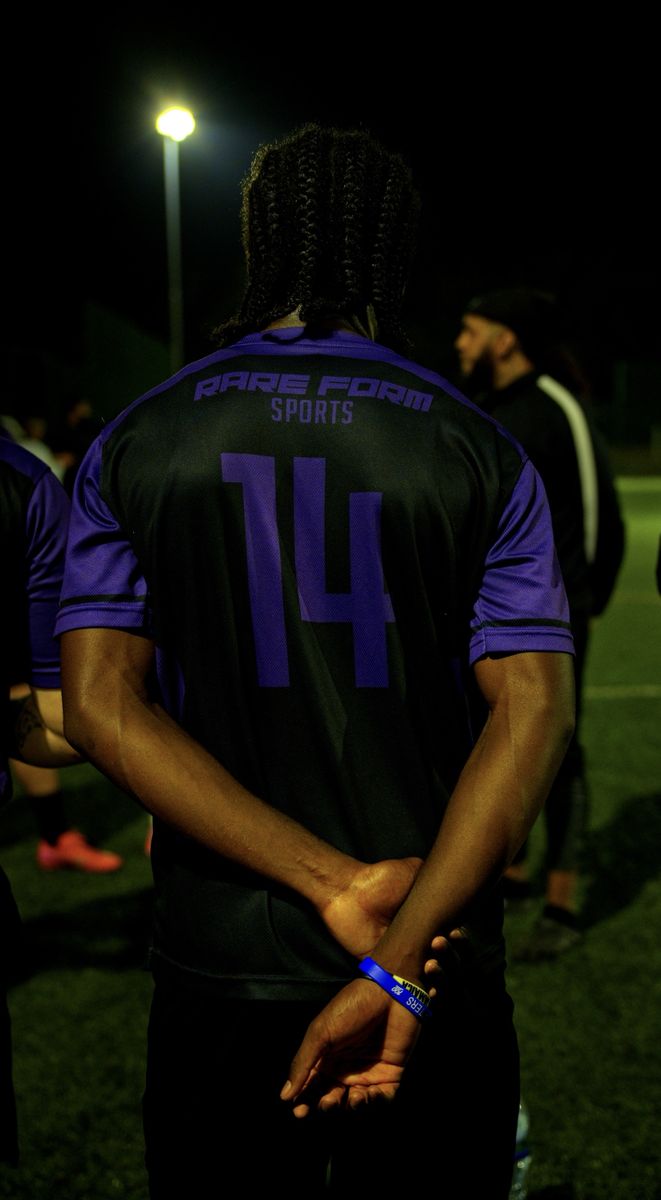 Rare Form Sports player in a number 14 shirt under floodlights